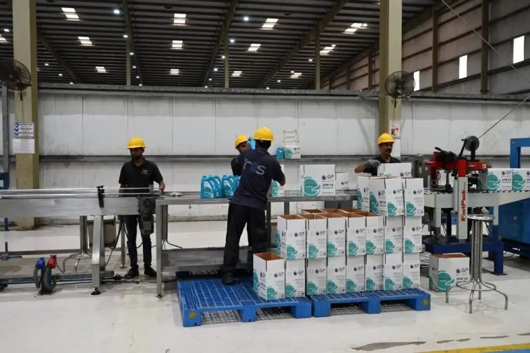 Operators packing cartons on the GP Pakistan packing line