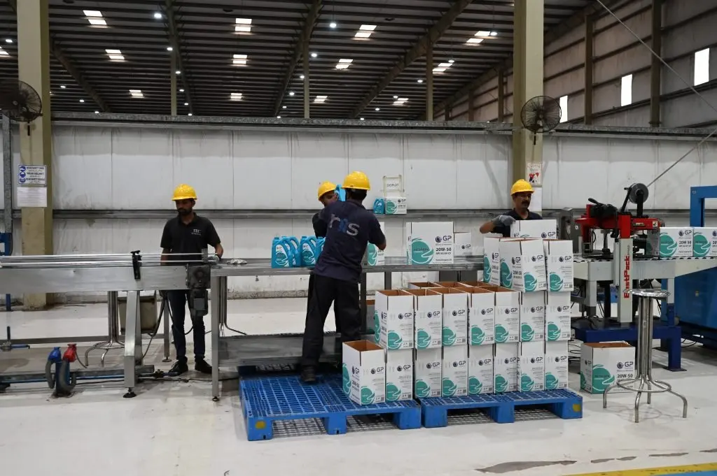 Operators packing cartons on the GP Pakistan packing line